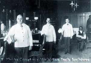 Barbers inside a turn of the century barber shop